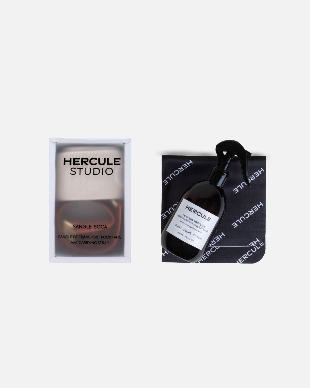 Set accessoires Hercule Studio comprenant spray assainissant pour tapis de sport et sangle de transport élégante, duo pratique pour nettoyer, transporter et entretenir tapis de yoga, Pilates et fitness, accessoires design Made in France, packshot produits