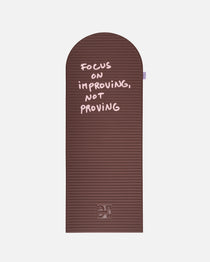 Hercule Studio x Thomas Lélu Limited Edition Exercise Mat, brown designer floor mat featuring a pink quote reading “focus on improving not proving,” an artistic collaboration for fitness, Pilates, and stretching, unfolded view