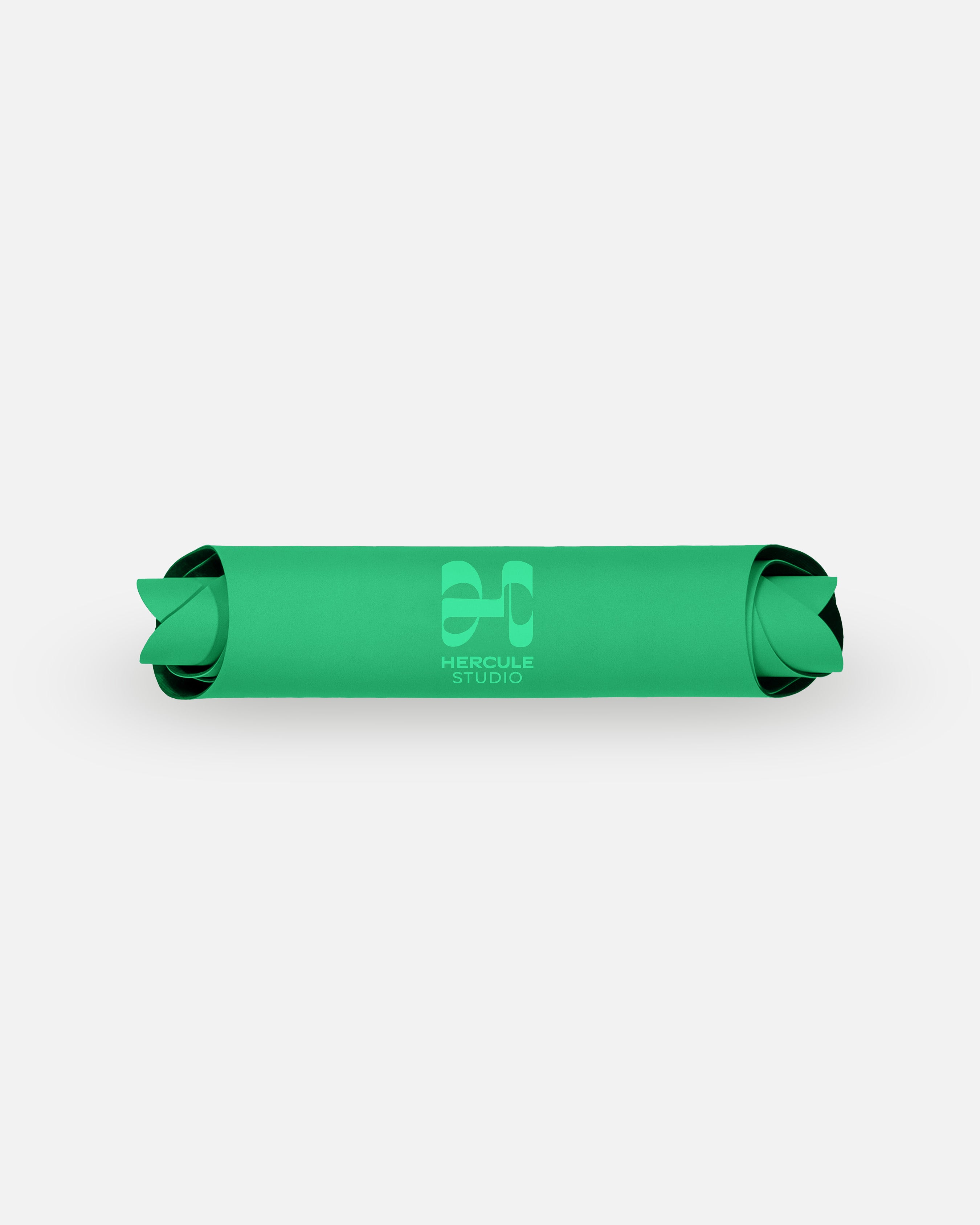 Packshot rolled view of the Hercule Studio Golf Green yoga mat, eco-friendly natural rubber, high grip for flow and balance